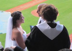 couple getting married at baseball park