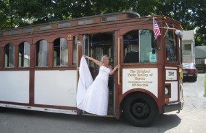 bride smiling in front of trolley