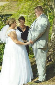 couple holding hands as they say their vows