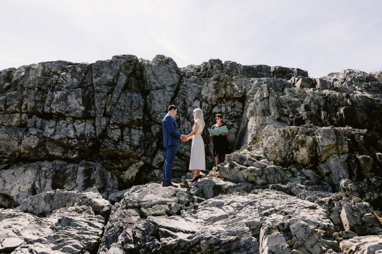 couple getting married on rocks
