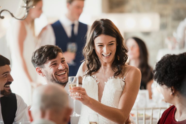 happy bride and groom enjoying their wedding day with guests and champagne