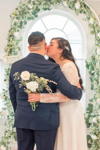 bride kissing grooms cheek on wedding day
