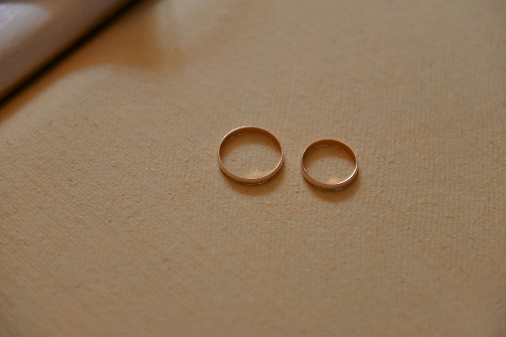 wedding bands sitting next to each other