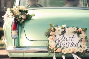 just married sign on the back of a teal old vehicle