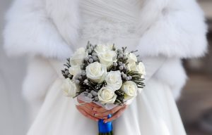 closee up of winter bride holding winter wedding bouquet