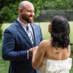 couple holding hands saying i do