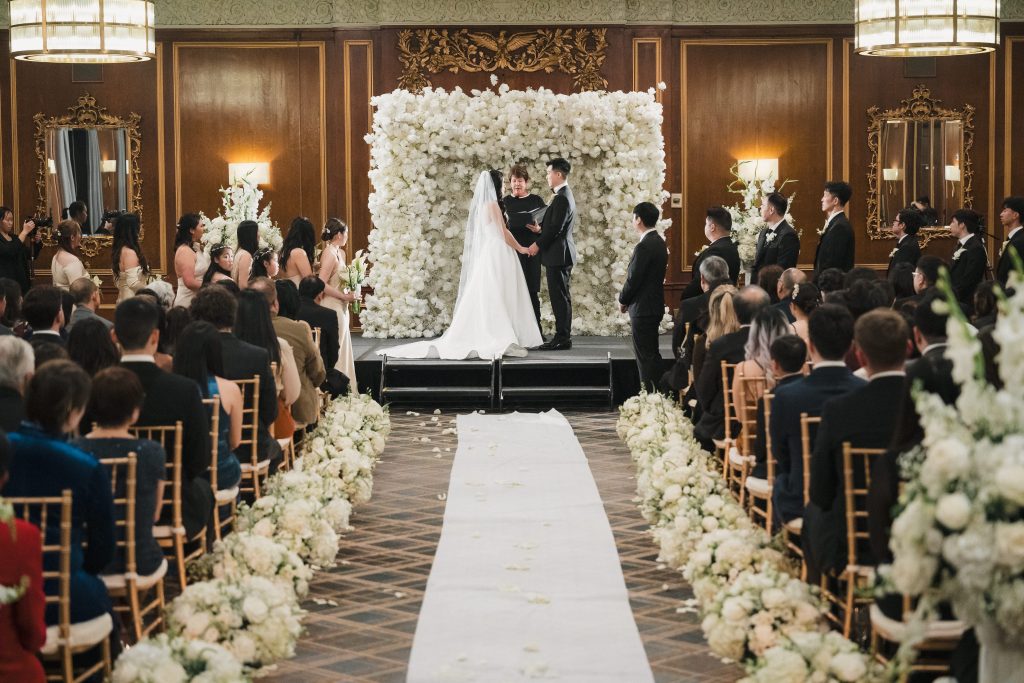aisle view of couple getting married inside boston park plaza hotel