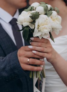 wedding day, bride and groom holding flowers